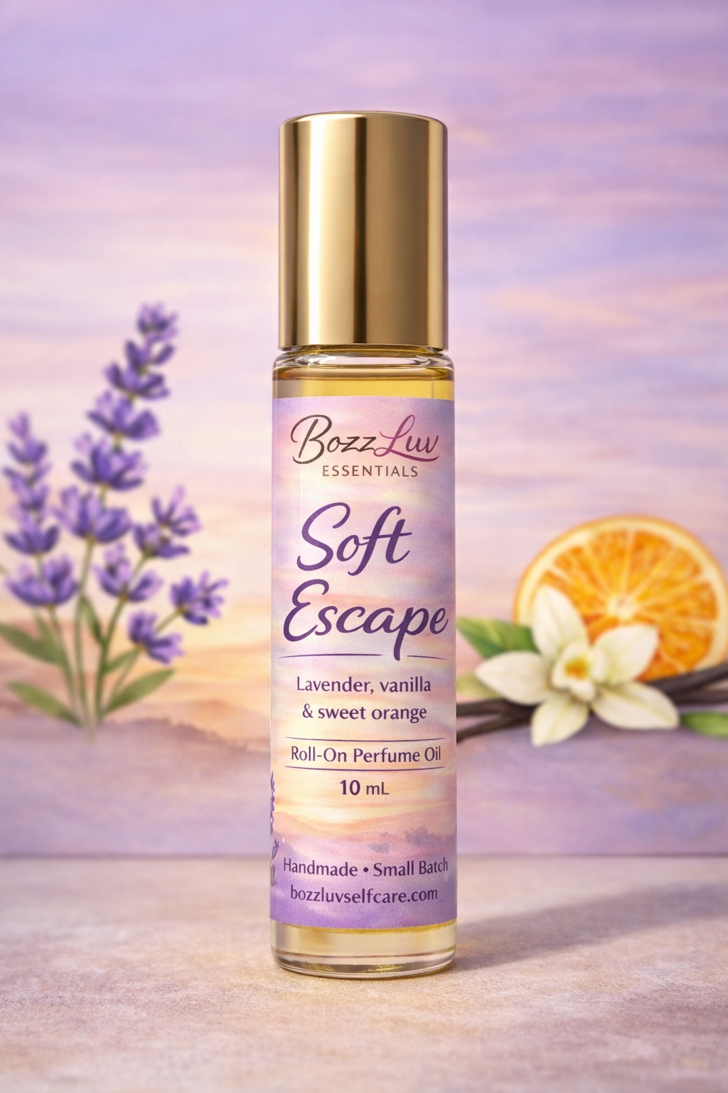Roll-on perfume oil bottle labeled 'Soft Escape' by Bozz Luw with lavender and orange flowers in the background. BozzLuv Essentials Soft Escape roll-on perfume oil in a 10 mL glass bottle with gold cap and lavender-toned label