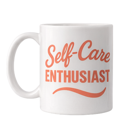 White mug with 'Self-Care ENTHUSIAST' text in coral on a white background