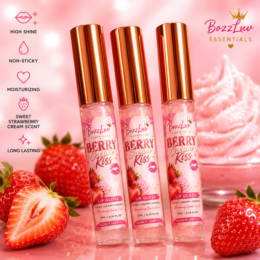 Berry Cream Kiss Lip Gloss by BozzLuv Essentials in clear pink gloss tubes with rose gold caps, displayed with strawberries and whipped cream on a soft pink background.