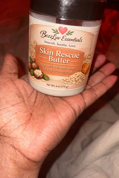 Hand holding a jar of Bozz Liv Essentials Skin Rescue Butter against a blurred background. BozzLuv Essentials Skin Rescue Butter 6 oz fragrance-free body butter for dry sensitive skin.