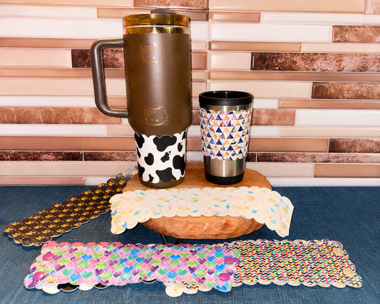 Assorted BozzLuv Snap-On Tumbler Sleeves for coffee cups and Stanley-style tumblers.
