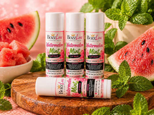 Bozzluv Watermelon Mint lip balm with watermelon and mint leaves on a wooden board. BozzLuv Essentials Watermelon Mint Lip Balm tube – cooling and hydrating lip care
