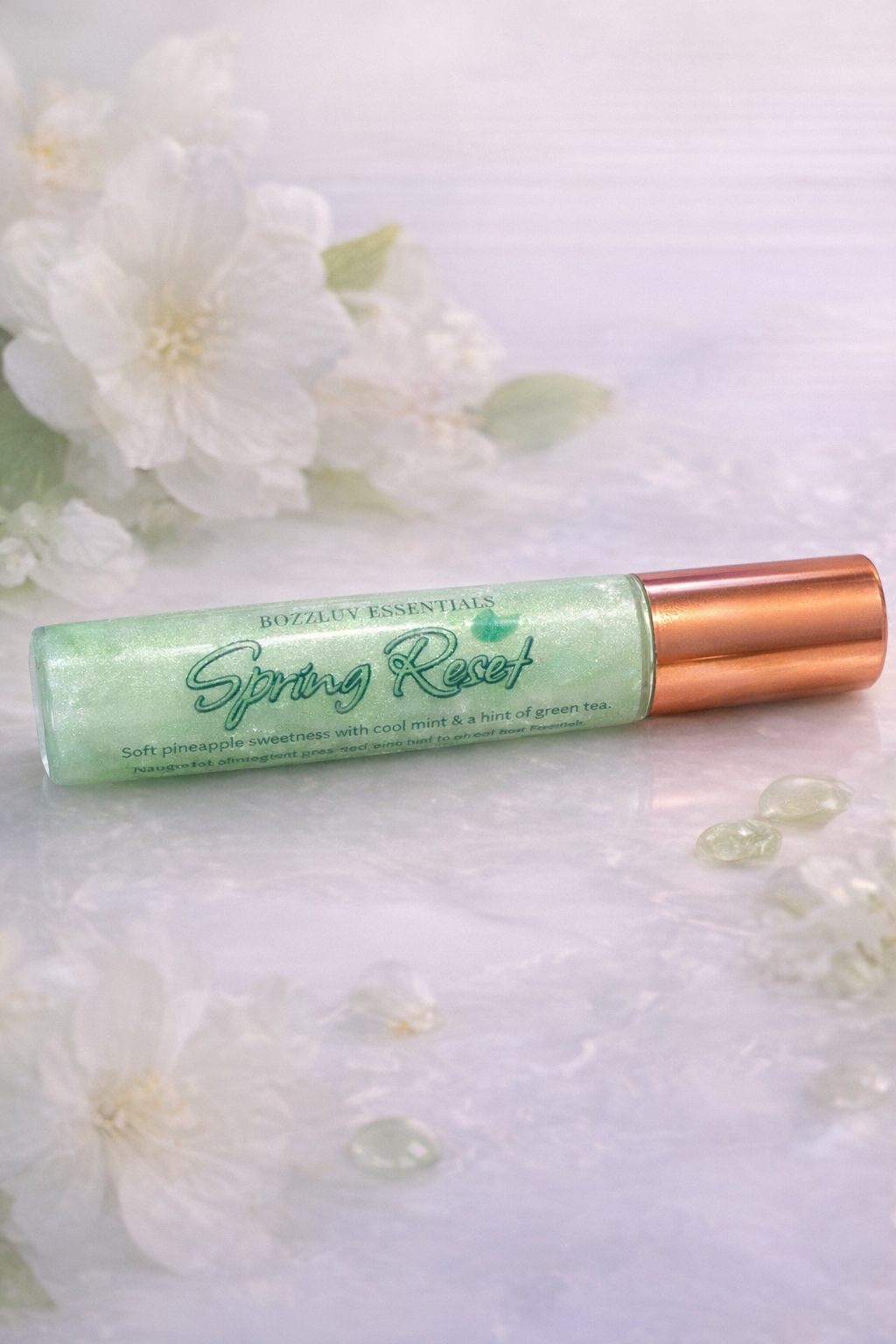 Spring Reset limited edition lip gloss by BozzLuv Essentials in frosted green with gold cap, pineapple mint scent.